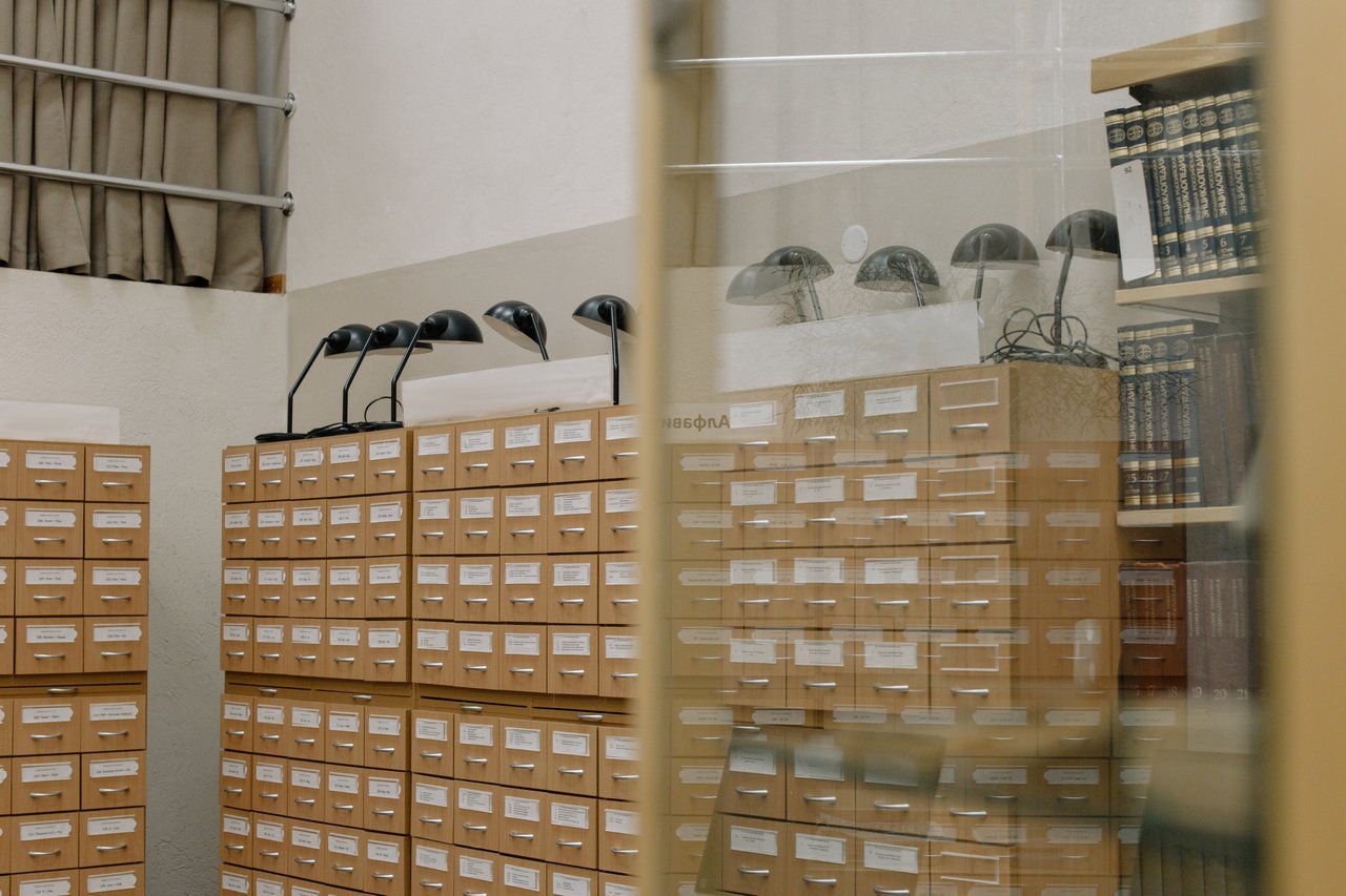 about-us Vintage library card catalog with classic lamps, symbolizing knowledge and organization.